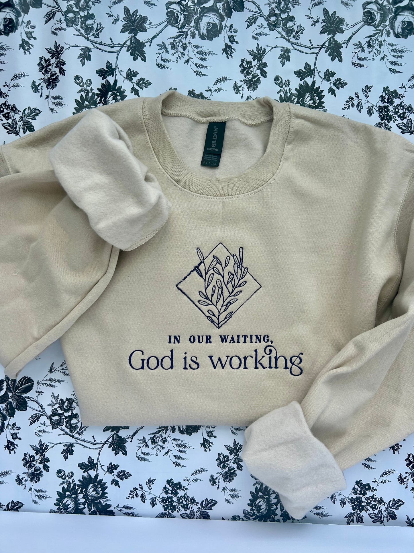 “In Our Waiting God is Working” Embroidered Soft Style Gildan Crewneck Sweatshirt